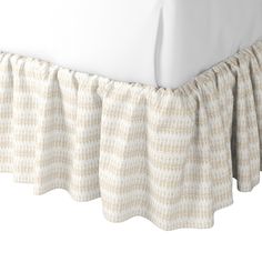 the bed skirt is made with white linen