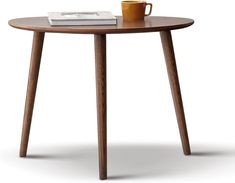 a wooden table with a coffee cup on it and a book sitting on top of it