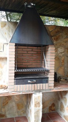 an outdoor fireplace with a grill attached to it