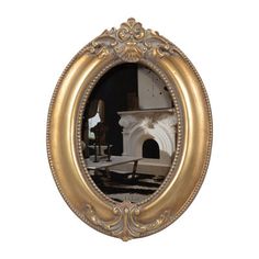 an oval gold frame with a fireplace in the middle and a chair on the other side