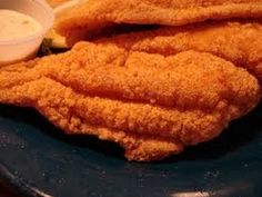 fried chicken and french fries on a plate with dipping sauce