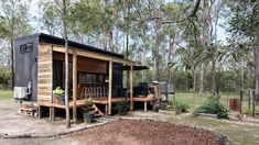 a tiny house in the middle of some trees