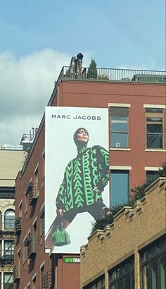 a large billboard on the side of a building with a man wearing a green jacket