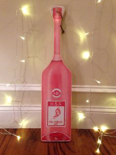 a pink bottle that is sitting on the floor next to some string lights and fairy lights