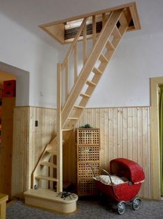 a wooden stair case next to a baby carriage