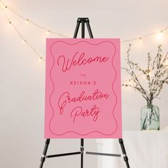 a pink sign with the words welcome to keisha's graduation party on it