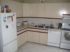 a white refrigerator freezer sitting inside of a kitchen next to a stove top oven