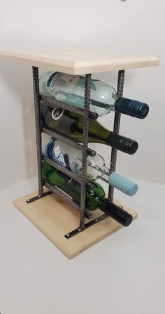 the wine rack is holding several bottles and other items on it's side,