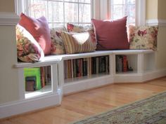 a living room filled with lots of furniture and pillows