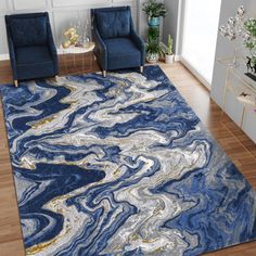 a living room with blue chairs and a rug on the floor that looks like marble