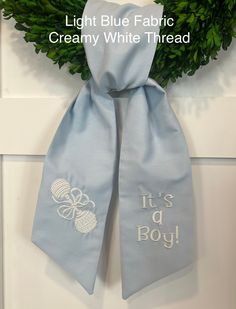 "This sweet Baby Rattle wreath sash is perfect for celebrating the birth of any new baby! Use at the baby shower, then tie on a wreath on your front door, baby's bedroom room, or on a mirror. This elegant and stunning keepsake is even more gorgeous in person. Be sure to watch the video to see the exquisite detailing on the baby rattle. Every baby needs this treasured heirloom! The sash comes customized to your needs. All sashes have the rattle embroidered on one tail and the triple monogram on t Baby Wreath For Hospital Door, New Baby Wreath, Baby Wreath, Baby E, Joann Fabrics, Baby Rattle, Wreath Bow, Pink Watercolor, Cute Packaging