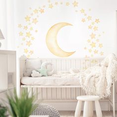 a child's room with stars and a crescent wall decal