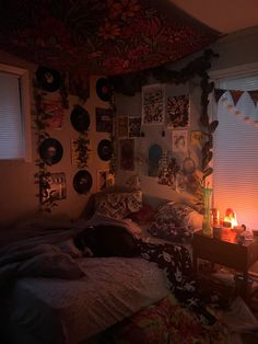 a bed room with a lit candle and pictures on the wall