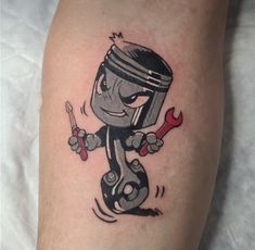 a cartoon character holding a wrench and spanner tattoo on the right leg,