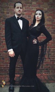 a man in a tuxedo and a woman in a black dress standing next to each other