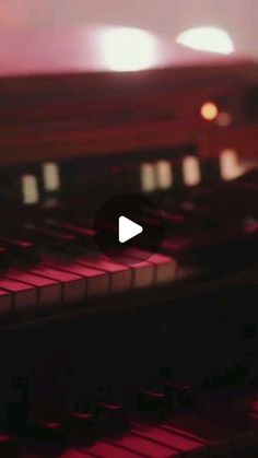 a close up of an electronic keyboard with blurry lights in the background