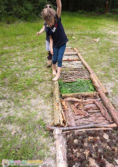 two children are playing on a wooden structure