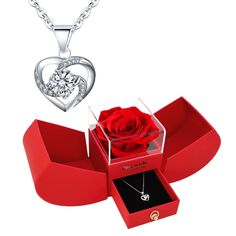 a red box with a rose in it and a heart shaped pendant on the necklace