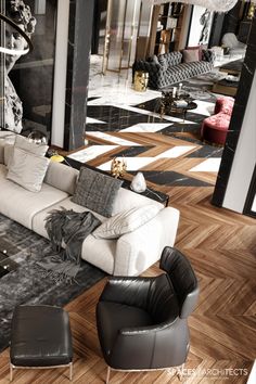 a living room filled with lots of furniture on top of a hard wood floor covered in black and white tiles