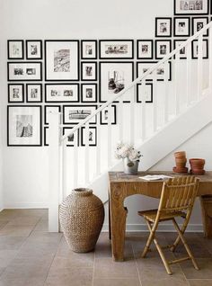 an image of a room with pictures on the wall and a table in front of it