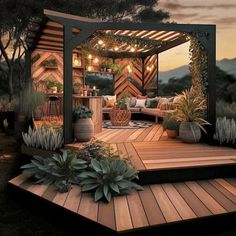 a wooden deck with potted plants and lights on the top area is lit up at night