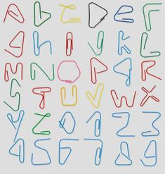 the letters and numbers are drawn with colored crayons on a white paper background