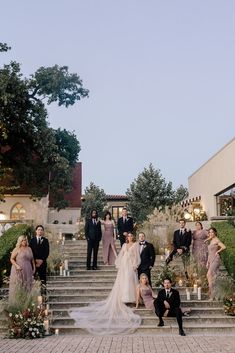 a group of people standing on top of a set of steps next to each other