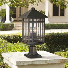 a lamp post sitting on top of a cement block