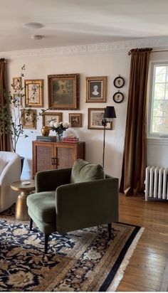 a living room filled with furniture and pictures on the wall