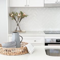 a kitchen counter with a basket on it next to a stove top oven and microwave