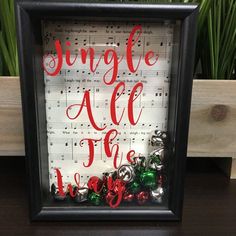 a framed sign with bells and sheet music in it that says, jungle all the ways