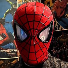 a spider man is standing in front of some movies