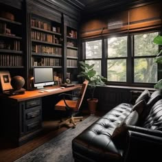 a home office with black leather couches and bookshelves in front of the window