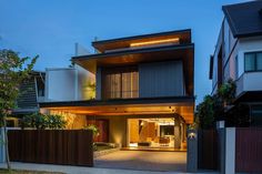 a modern house is lit up at night