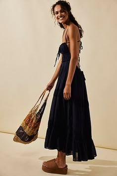 Just as effortless as it is versatile, this wear-everywhere maxi from our free-est collection is featured in a billowy, tiered silhouette with smocked detailing at the bodice and front tie detailing for added dimension.* Open back design* Adjustable, tie-back style* Lined Suspender Skirt, Navy Blazer, Silk Skirt, Back Design, Types Of Skirts, Brunei, Cotton Silk, Up Styles, Swing Dress