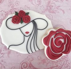 a decorated cookie with red roses on it