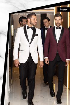 two men in tuxedos are walking down the hall with other men behind them