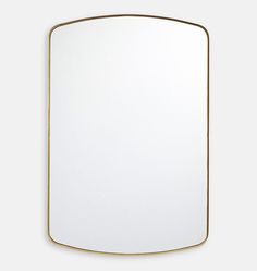 a white mirror with gold trim around the edges and an oval frame on the wall