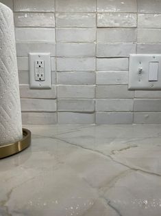 two rolls of toilet paper sitting on top of a counter