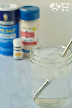 a glass jar filled with liquid and a spoon