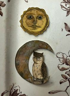 an owl is sitting on the crescent with a sun and moon in it's back