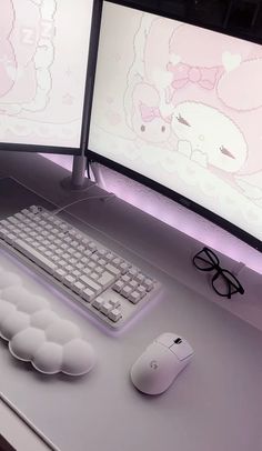 two computer monitors sitting on top of a desk next to a keyboard, mouse and glasses