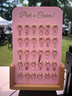 This unique display combines functionality with a chic aesthetic, making it the perfect addition to your permanent jewelry setup! Dimensions (without any base): 30 CHARM DISPLAY = approx. 6" x 8" 50 CHARM DISPLAY = approx. 8" x 8" 100 CHARM DISPLAY = approx. 10" x 11.75" --- PLEASE NOTE: Wooden stands are NOT offered with 100 charm displays! ---- Now featuring a sturdy wooden base and adorned with strategically placed rivets, adding an edgy yet refined flair. The rivets not only serve as eye-cat Charm Display Ideas, Charm Bar Display, Permanent Jewelry Display, Jewelry Vendor Display, Jewelry Display Ideas, Charm Display, Creative Jewelry Displays, Handmade Jewelry Display, Vendor Displays