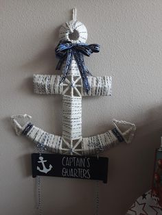 an anchor made out of twine and rope hanging on the wall