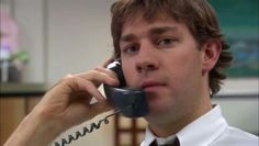 a man talking on a phone while wearing a tie