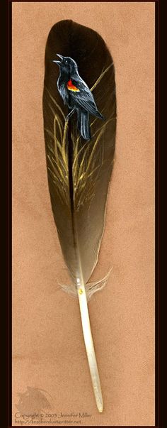 a feather with a bird painted on it