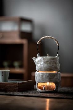 a tea pot sitting on top of a wooden table