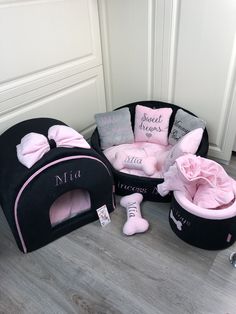 three black and pink pet beds with bows on them, one for a girl the other for a boy