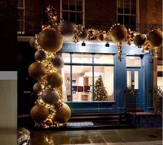 a store front decorated with christmas lights and ornaments