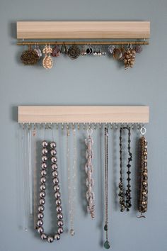 several necklaces are hanging on the wall